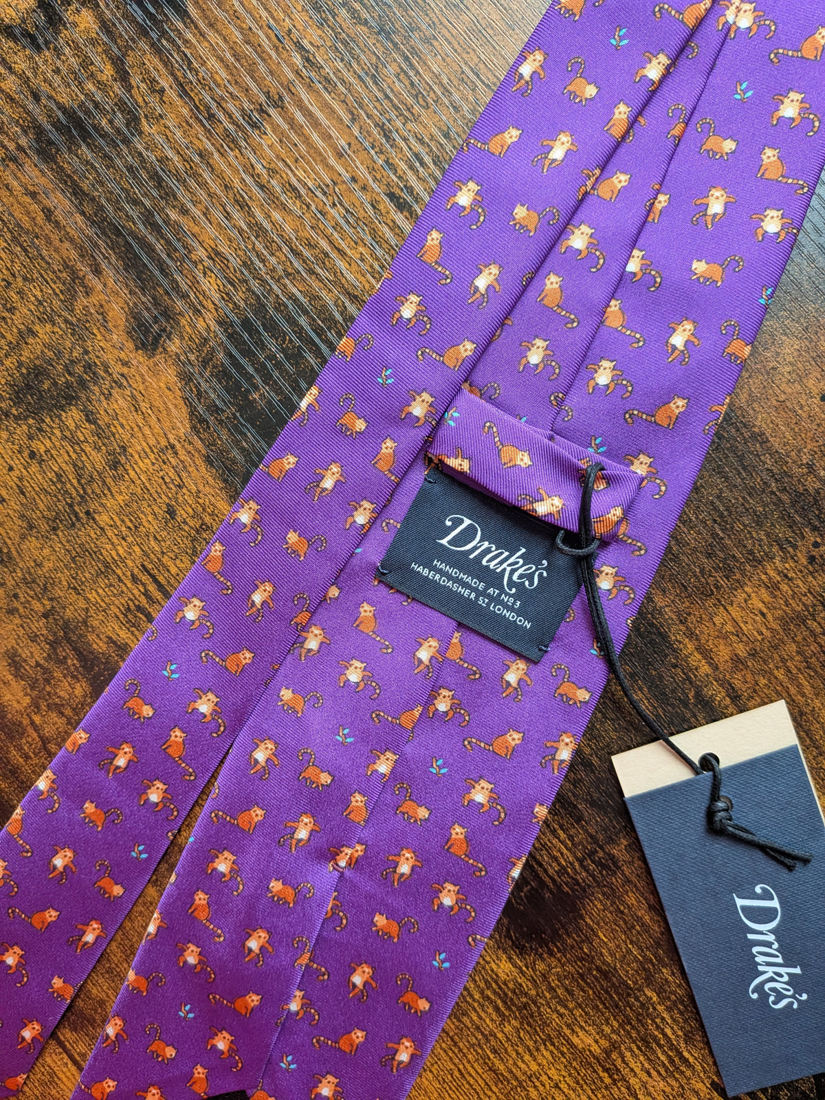 Drake's red panda motif handmade tipped silk tie detail view 4