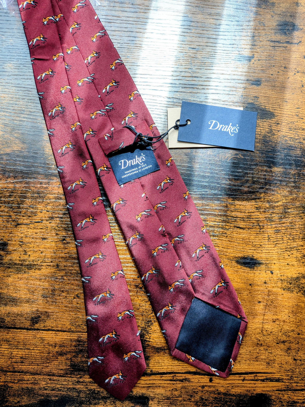 Drake's burgundy fox motif handmade silk tie detail view 2