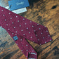 Drake's burgundy handmade polka dot hand rolled silk tie detail view 2