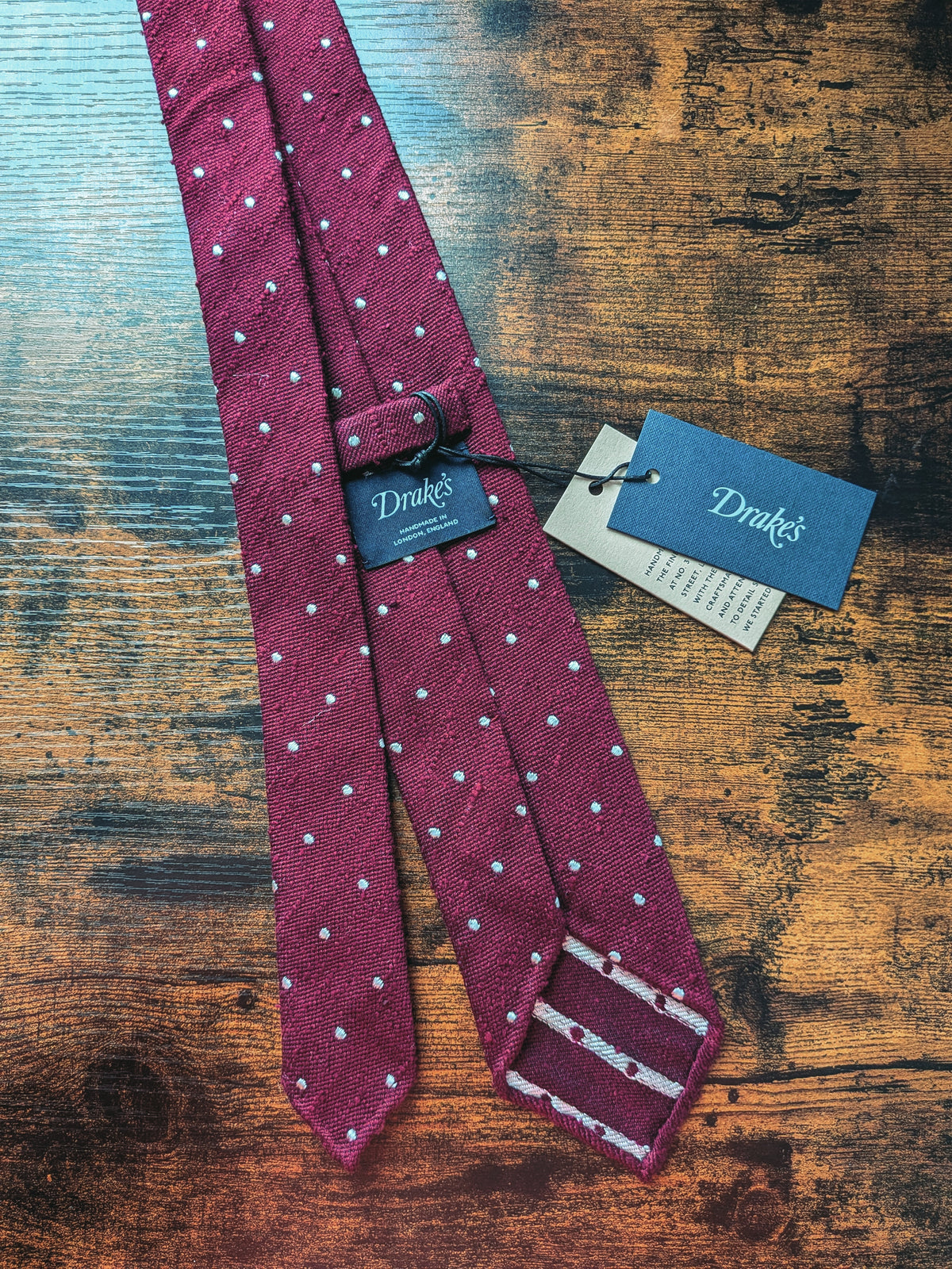Drake's burgundy handmade polka dot hand rolled silk tie detail view 3