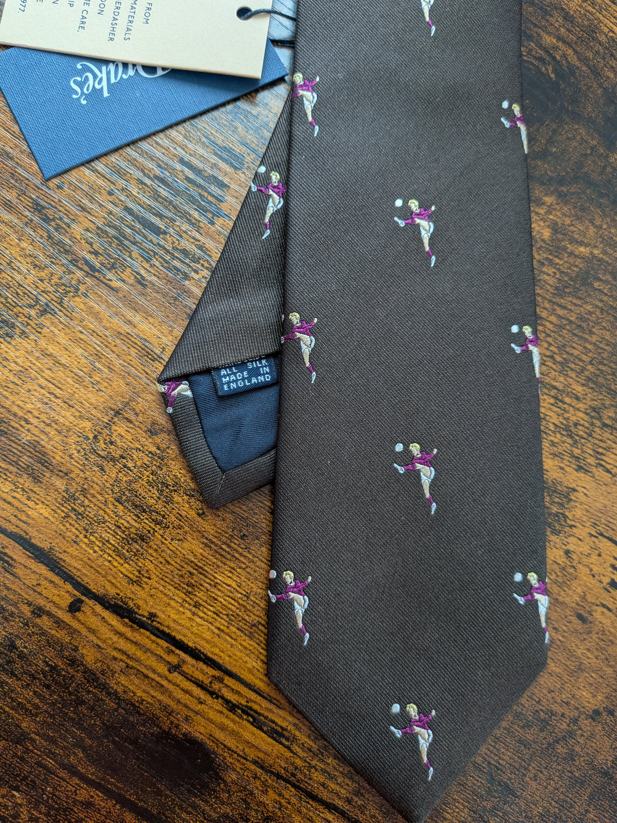Drake's dark brown football motif handmade tipped silk tie detail view 2