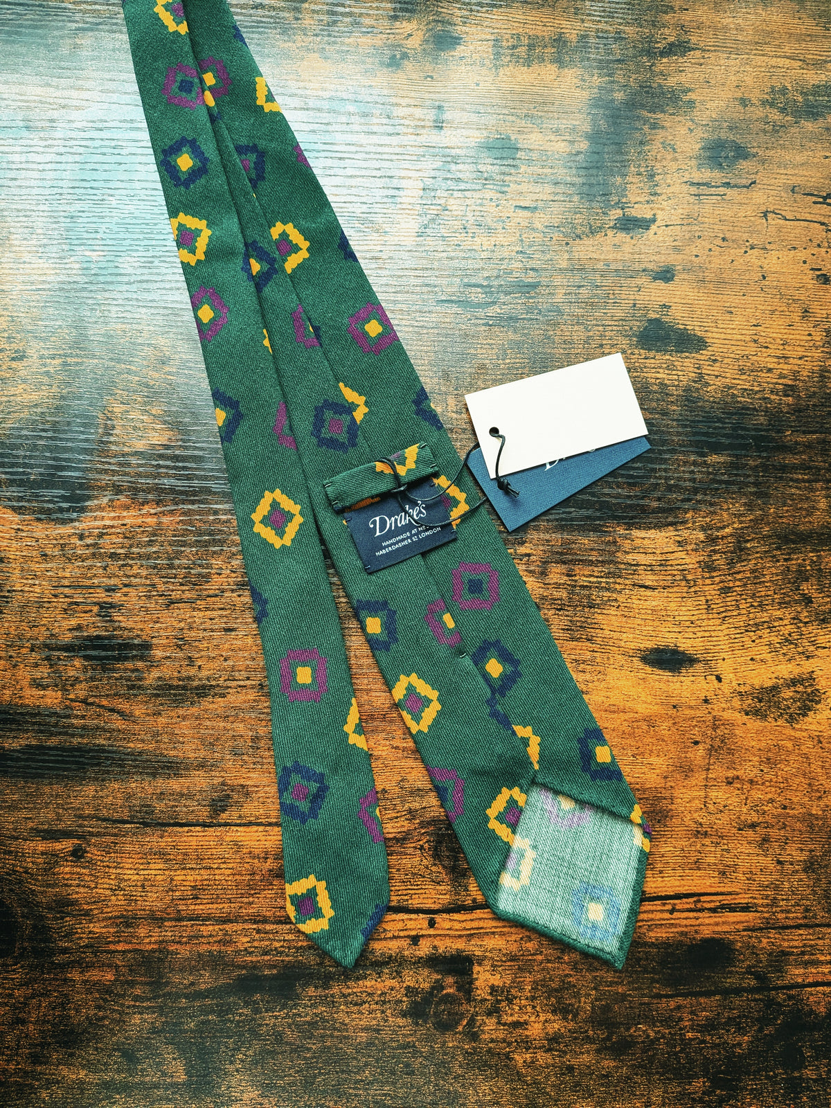 Drake's dark green geometric handmade silk tie detail view 2