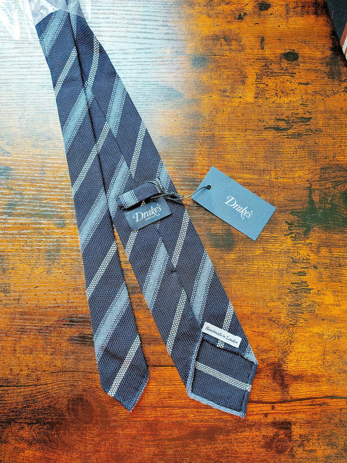 Drake's grenadine navy blue handmade striped silk tie detail view 2