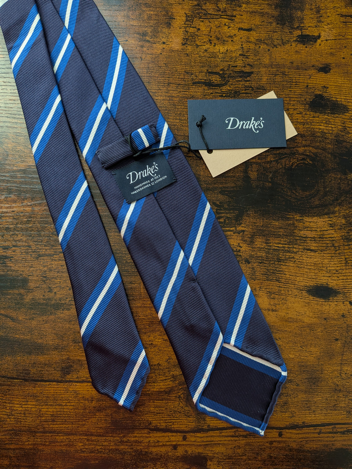 Drake's navy blue white striped handmade silk tie detail view 2