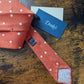 Drake's orange white handmade polka dot hand rolled silk tie detail view 2