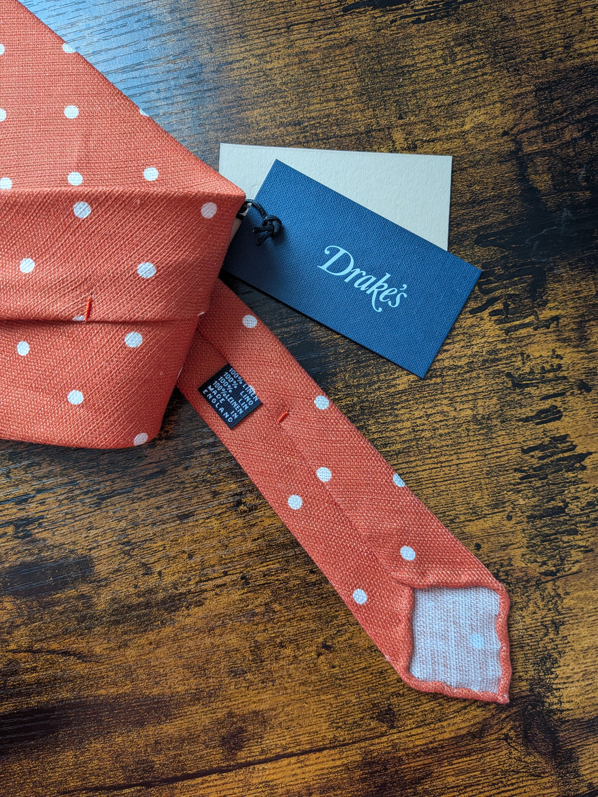 Drake's orange white handmade polka dot hand rolled silk tie detail view 2