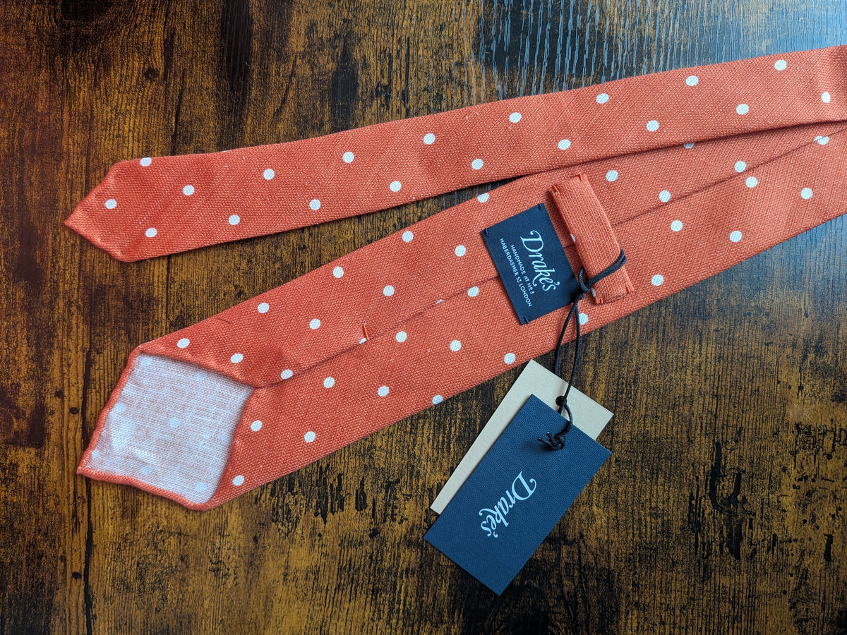 Drake's orange white handmade polka dot hand rolled silk tie detail view 3