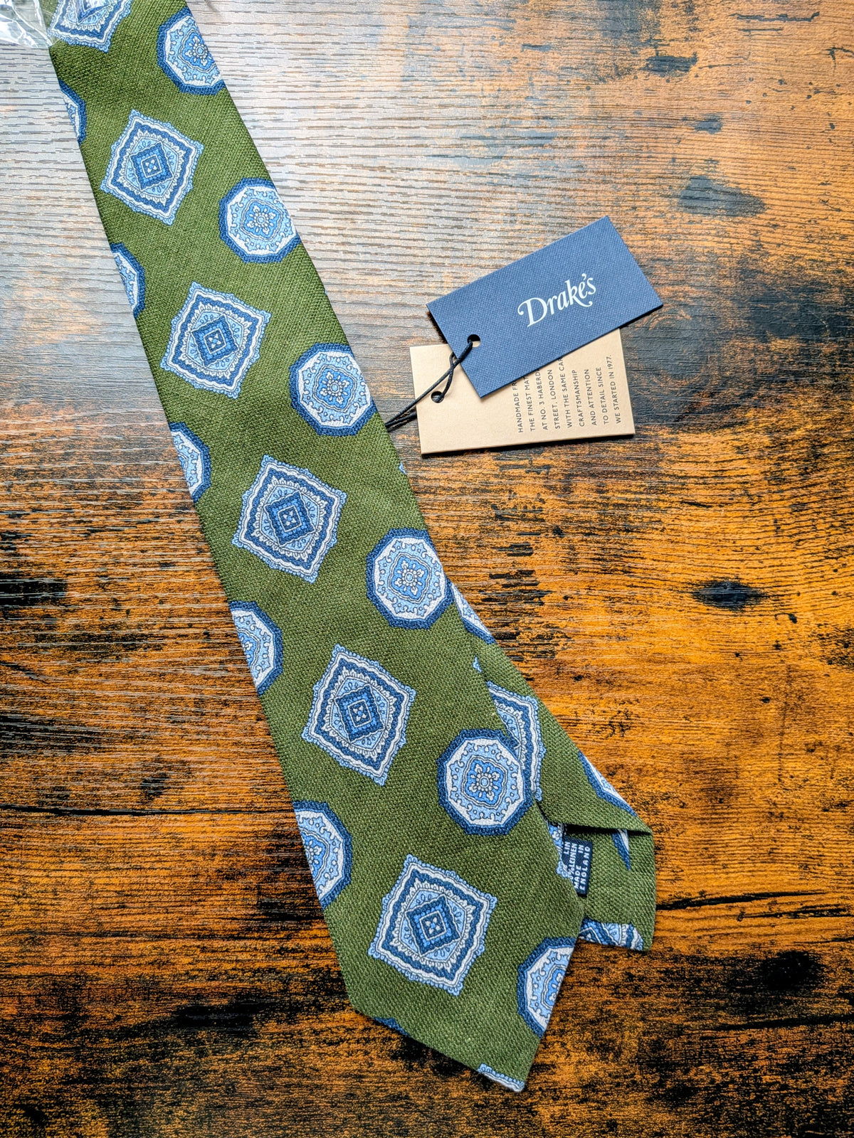 Drake's sage green blue geometric handmade silk tie detail view 2